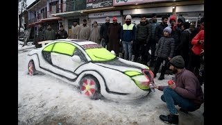 Youth makes car model out of snow in Srinagar