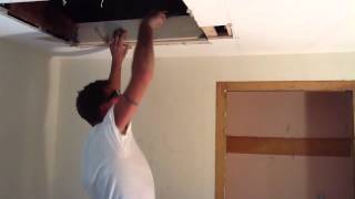 One Man cuts in a attic access  and cuts in a ceiling fan box.