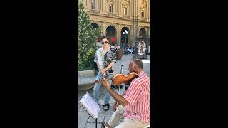 Henry and famous street violinist play a romantic duet using 1 violin