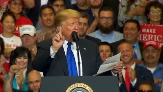 Trump reads lists of accomplishments from a piece of paper at rally