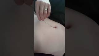 Navel stab with knitting needle