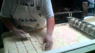 Beignets being made at Cafe Du Monde in New Orleans, LA