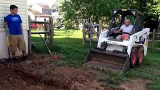 Excavating for a paver patio with a Bobcat S100 - Ryan's Landscaping
