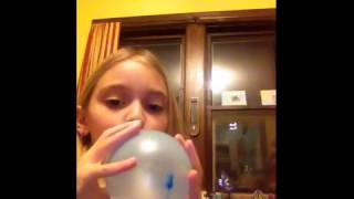 Balloon pops when girl inflates it