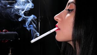 Black-haired Russian girl is smoking a 100mm cigarette in this close up fetish video
