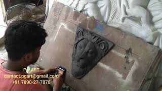 Relief lion face making out of mud