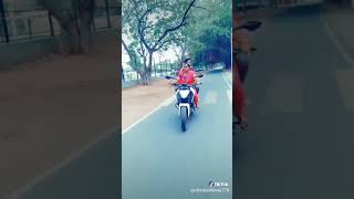 Mom riding son's bike with her son sitting behind