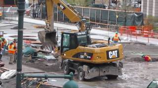 Caterpillar M315D wheeled excavator in action