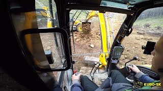 JCB 8085 excavator ripping and moving rocks - cab view