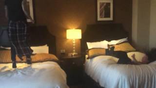 Two girls slow mo bed jumping