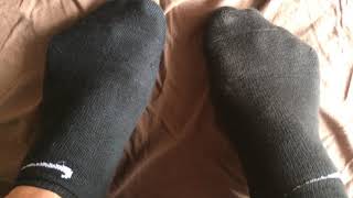 sneaker off and black sweaty socks