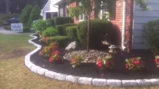 Techo-bloc walls, steps and cobblestone borders with landscape design and plantings