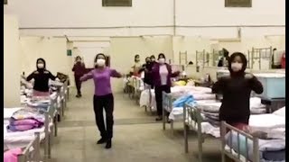 Coronavirus patients dance at makeshift Wuhan hospital