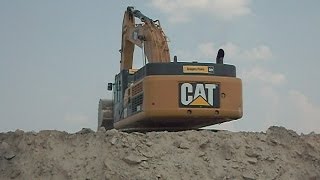 CATERPILLAR 349L EXCAVATOR LOADING SAND ON VOLVO 40 TON OFFROAD TRUCK