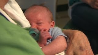 Volunteer 'cuddlers' comfort babies