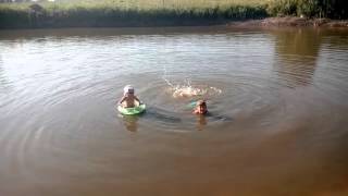 Games on the water. Children swimming lake. On the river Игры на воде. Дети плавают озере. На реке