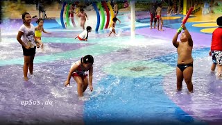 Happy Children Play on the Wet Water Playground.