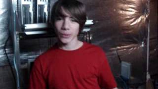 Cute boy takes his shirt off