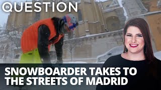 Snowboarder takes to Madrid streets for wild ride